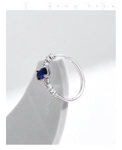 Macro shot of S925 sterling silver ring featuring an oval blue sapphire gemstone