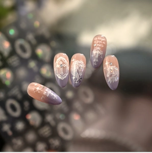 Detailed view of unicorn nail decals with silver rhinestones on pink gradient nails