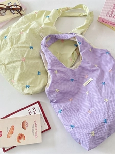 Embroidered bow canvas shoulder bag with waffle texture in light green and purple colors