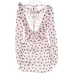 Detail of red polka dot white chiffon dress with open back and lace-up design