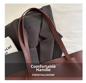 Detail of reinforced thick handle on brown faux leather tote bag for women