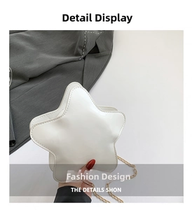 Close-up of white star-shaped bag with glossy patent leather finish and gold chain strap