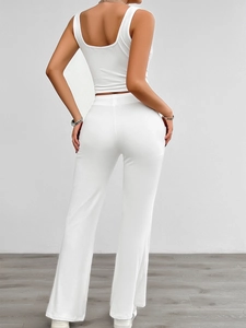 Rear view of white sleeveless crop top and high-waisted flare pants yoga set