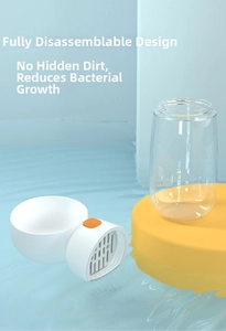 Close-up of detachable portable pet water bottle parts on blue water background