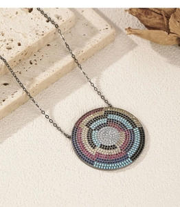 Macro shot of S925 silver pixelated shield pendant with colorful crystals on stone background
