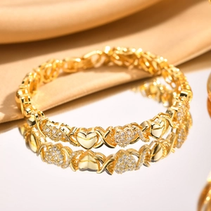 Detailed macro view of 18K gold plated XO heart bracelet with pavé white zircons