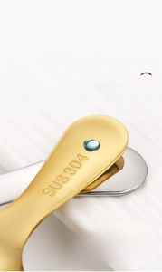 Close-up of SUS 304 stainless steel spoon handle with brushed golden finish texture