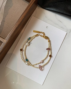 Detail of double-layer beaded bracelet featuring freshwater pearls and gold plating