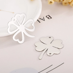 Minimalist silver titanium steel four-leaf clover pendant on neutral background