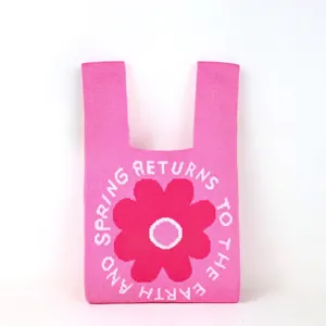 Detailed view of the thick knit texture and pink floral pattern on a bucket bag