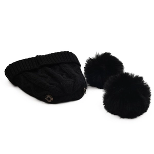 Black cable knit beanie featuring dual detachable pom poms and snap button details