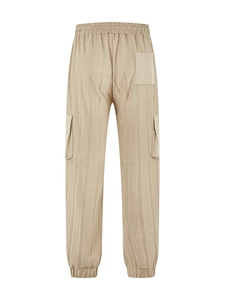 Detail view of khaki cargo pants showing elastic waistband and textured fabric detail