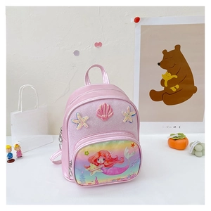 Detail of pink mermaid backpack featuring glitter surface and 3D shell decorations