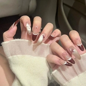 French bow press-on nails with burgundy and cat-eye gold almond shape design