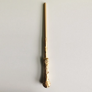 Close-up of golden magic wand featuring detailed elderberry wood texture for kids cosplay