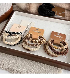 Detailed view of woven hair scrunchies with decorative wooden beads in earthy tones