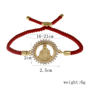 Detail view of adjustable red braided bracelet with gold Virgin Mary zircon pendant