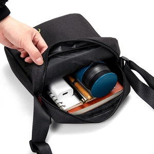 Black waterproof oxford crossbody bag for men showing large capacity internal compartment