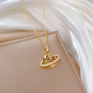 Elegant gold titanium necklace featuring a dazzling rhinestone planet pendant on silk