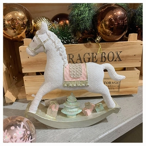 Detail of resin rocking horse ornament with knit texture and pastel Christmas decor