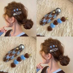 Detail of houndstooth clip with large pearl and blue flocked heart hair claw set