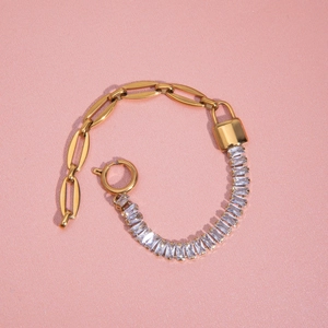 Detailed shot of gold bracelet with zircon inlay and stylish paperclip chain links