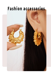 Detailed macro view of 18k gold plated hollow flower earrings with wrinkled metal texture