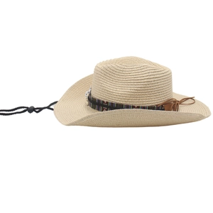 Detail of beige woven cowboy hat showing ethnic pattern band and silver metal buckle