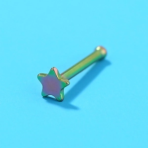 Macro shot of a rainbow-colored stainless steel nose stud with a star design