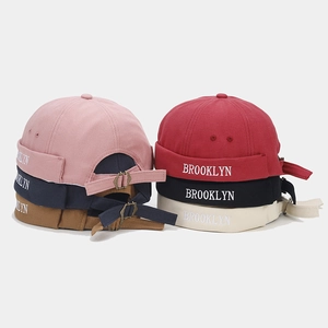 Detailed view of Brooklyn embroidery and adjustable metal buckle on Miki Hats