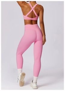 Pink yoga set featuring cross-back sports bra and high-waist leggings back detail