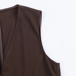 Detailed close-up of dark brown twill fabric with V-neckline stitching on a sleeveless top
