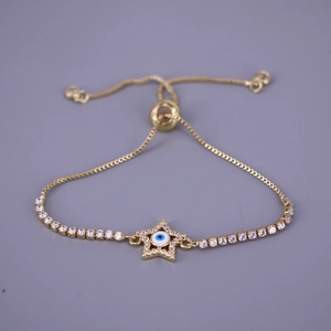 Detail of gold star bracelet with evil eye motif and pavé cubic zirconia inlay