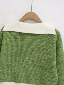 Detail of green and white knit texture on the collar and back of the women's sweater