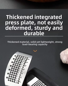 Detailed macro view of the thickened stainless steel garlic rocker with ergonomic handle