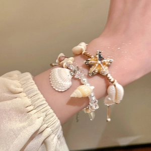 Bohemian style bracelet set featuring starfish charms and ceramic pearls for beach vacations
