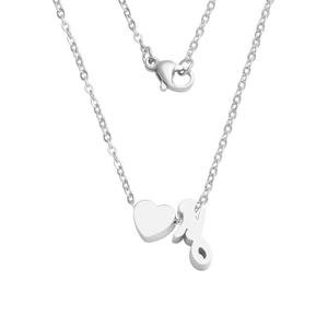 Detailed macro view of silver mirror-finish stainless steel heart and letter pendant