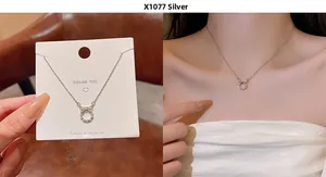 Detail view of silver titanium necklace with zircon bow wreath pendant on model