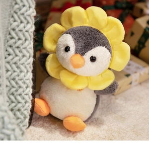 Macro detail of plush penguin toy with sunflower headgear in a cozy gift setting