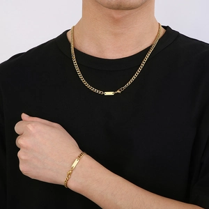 Hip hop gold Cuban link necklace and bracelet set with square tag on a male model
