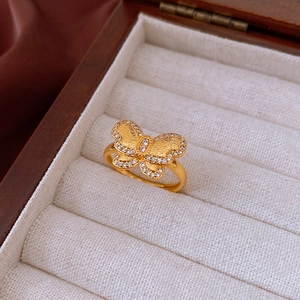 Close-up of gold plated butterfly ring with micro-set zircons in a jewelry box