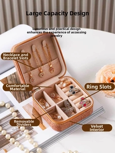 Detail of vintage pink gold jewelry box featuring necklace hooks and velvet ring slots