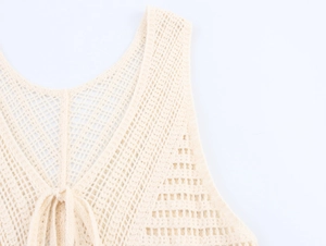 Close-up of beige crochet knit vest showing intricate mesh texture and V-neck drawstring