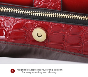 Makro-Detail der roten Handtasche mit Krokoprägung, Goldmagnetverschluss und Reißverschluss