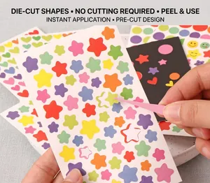 Close-up of heart stickers being applied with tweezers showing the die-cut design