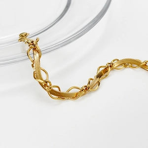 Detailed close-up of 18k gold-plated snake chain and textured link layered necklace