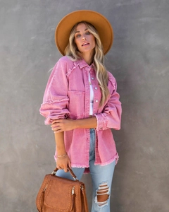 Detail of pink corduroy jacket with frayed edges and textured button-up shirt style
