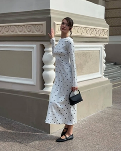 Close-up of white long-sleeve polka dot dress with elegant round neck and slim-fit texture