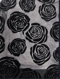 Detail shot of grey mesh fabric featuring elegant black flocked velvet rose patterns