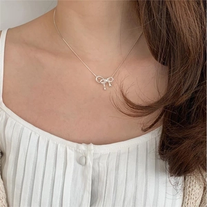 Minimalist 925 sterling silver bow pendant necklace with snake chain on model